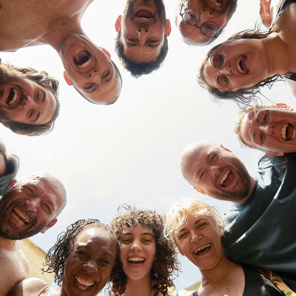 Workshop participants laughing together in a circle