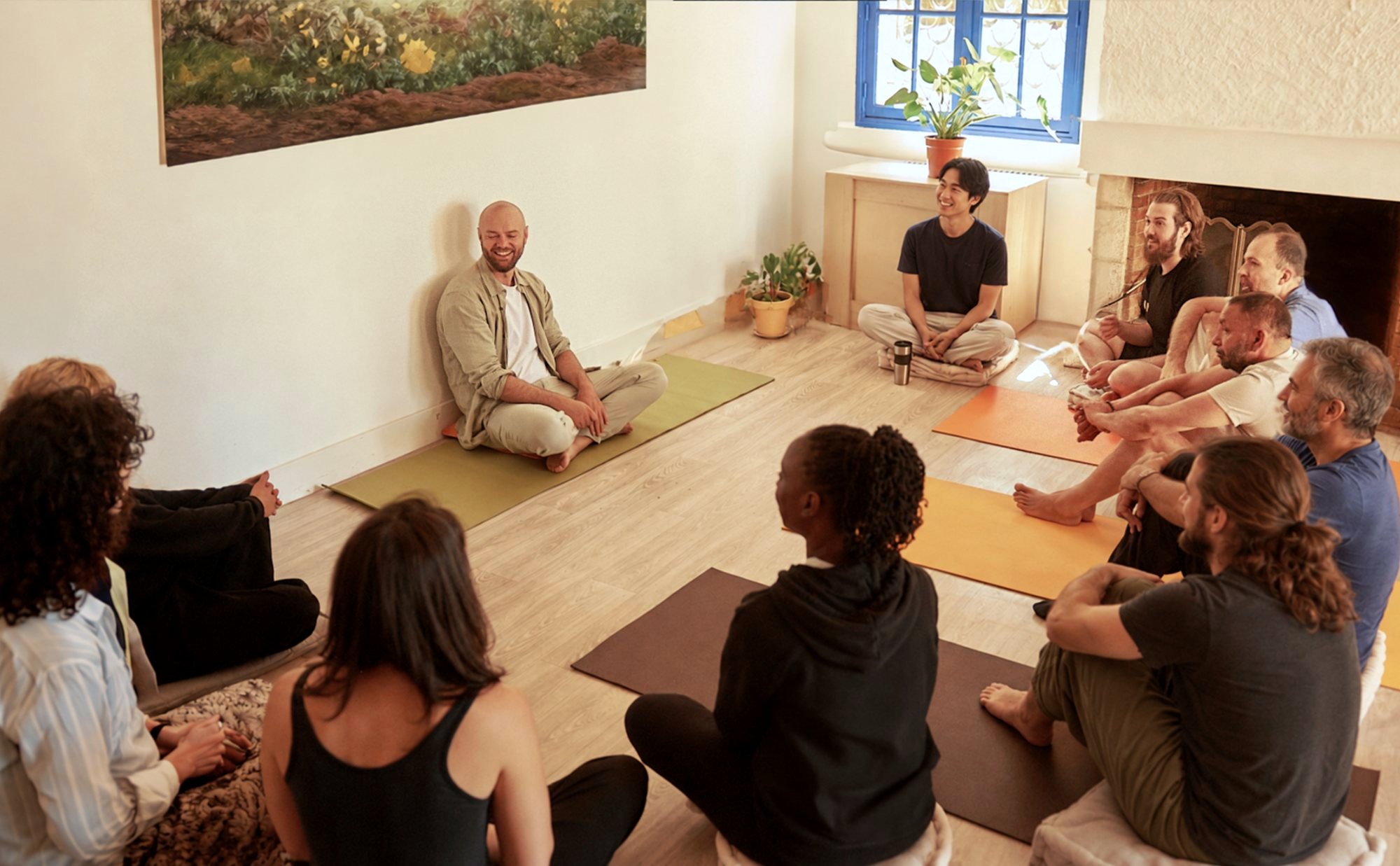 Olivier Passebecq laughing in a circle with a group during a workshop